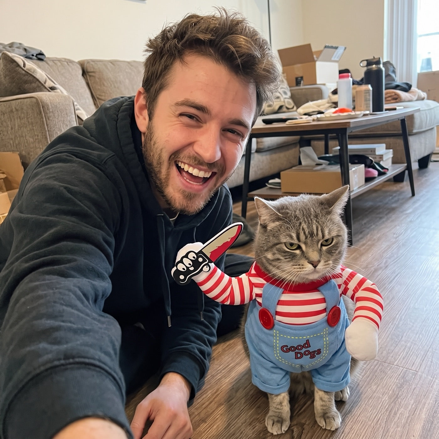 Jake laughing beside his gray cat in the Killer Kittens costume