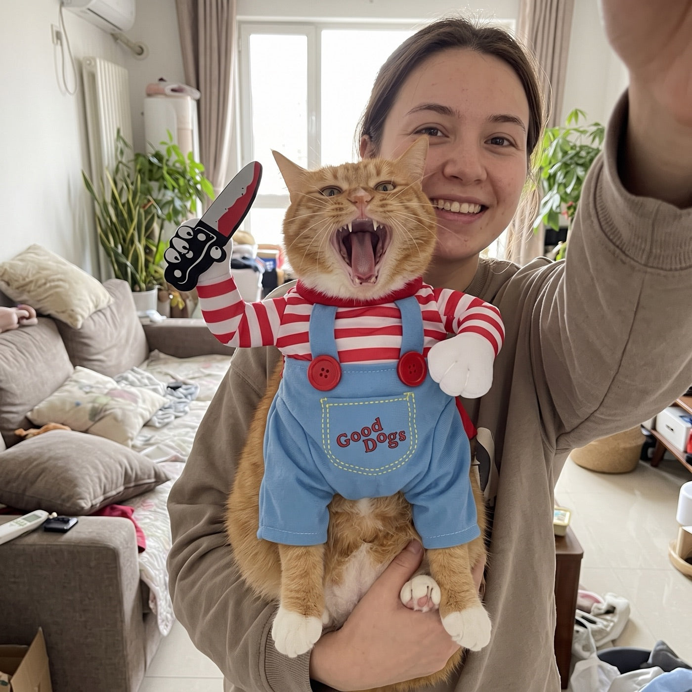 Mia holding her orange cat in the Killer Kittens costume